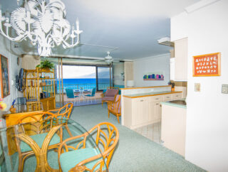 Dining area in foreground, Large flat screen TV on wall